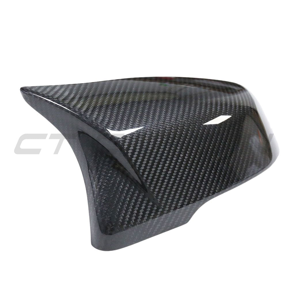 Toyota Supra A90 carbon fibre mirror accessories by CT Carbon, close-up of sleek, aerodynamic side mirrors with carbon fibre finish.