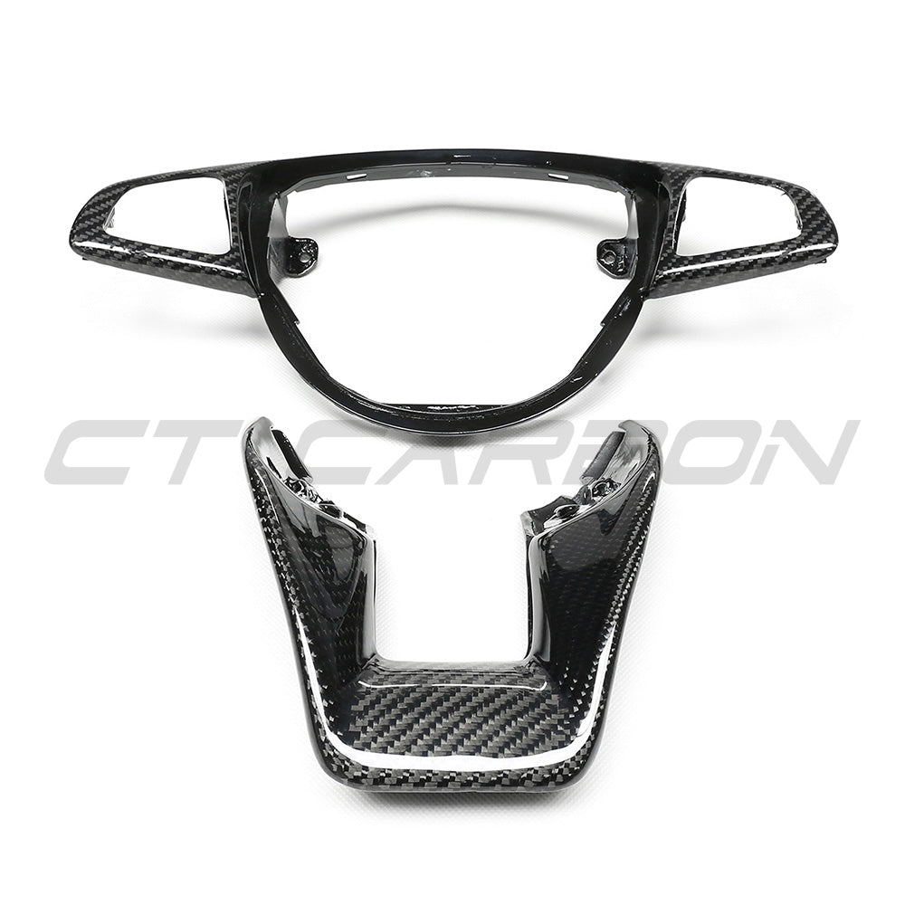 Mercedes AMG carbon fiber steering wheel trim by CT Carbon, close-up of sleek black carbon fiber accessory with textured finish.