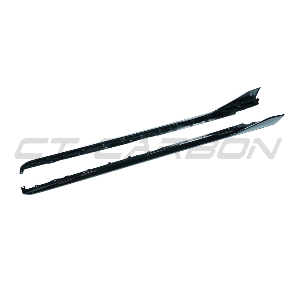 BMW F40 1 Series 2019-2024 CT Carbon gloss black side skirts installed on the car's sides.