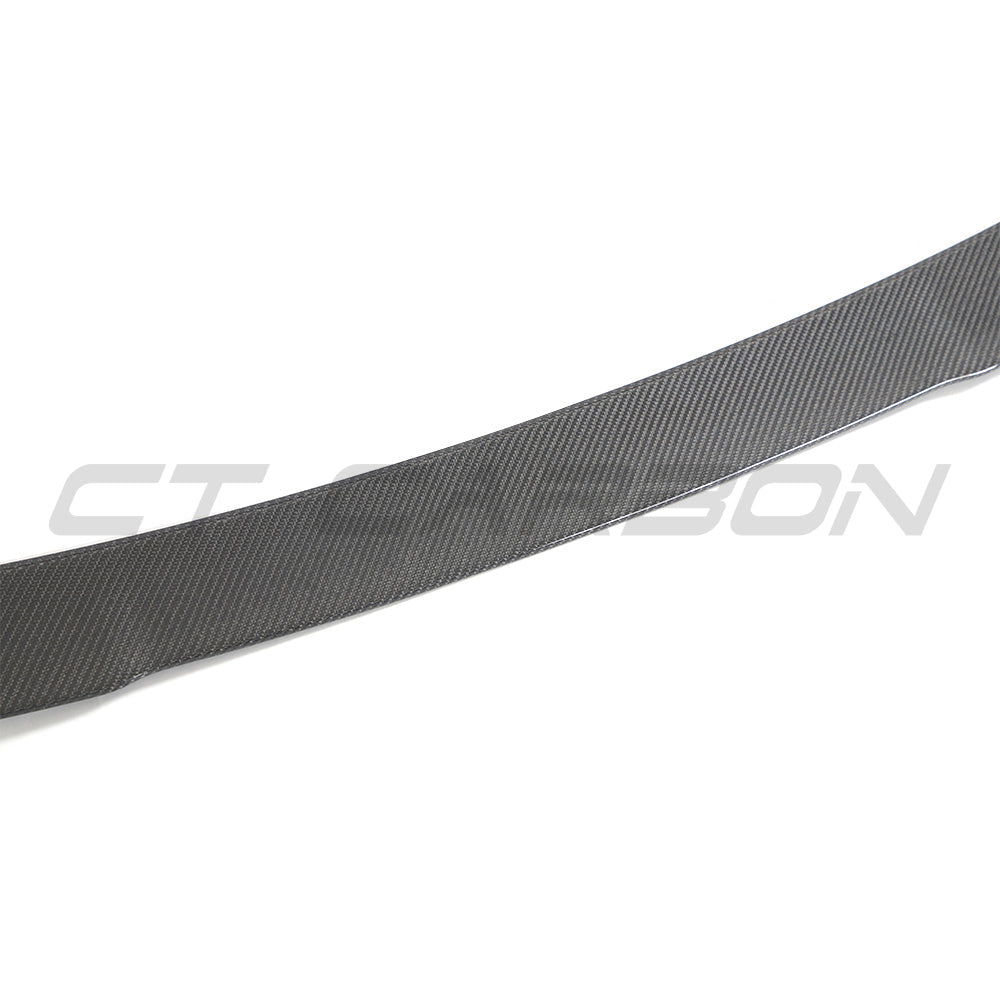 BMW G02 X4 and F98 X4M carbon fibre spoiler by CT Carbon, showcasing the sleek, aerodynamic design on the car's rear.