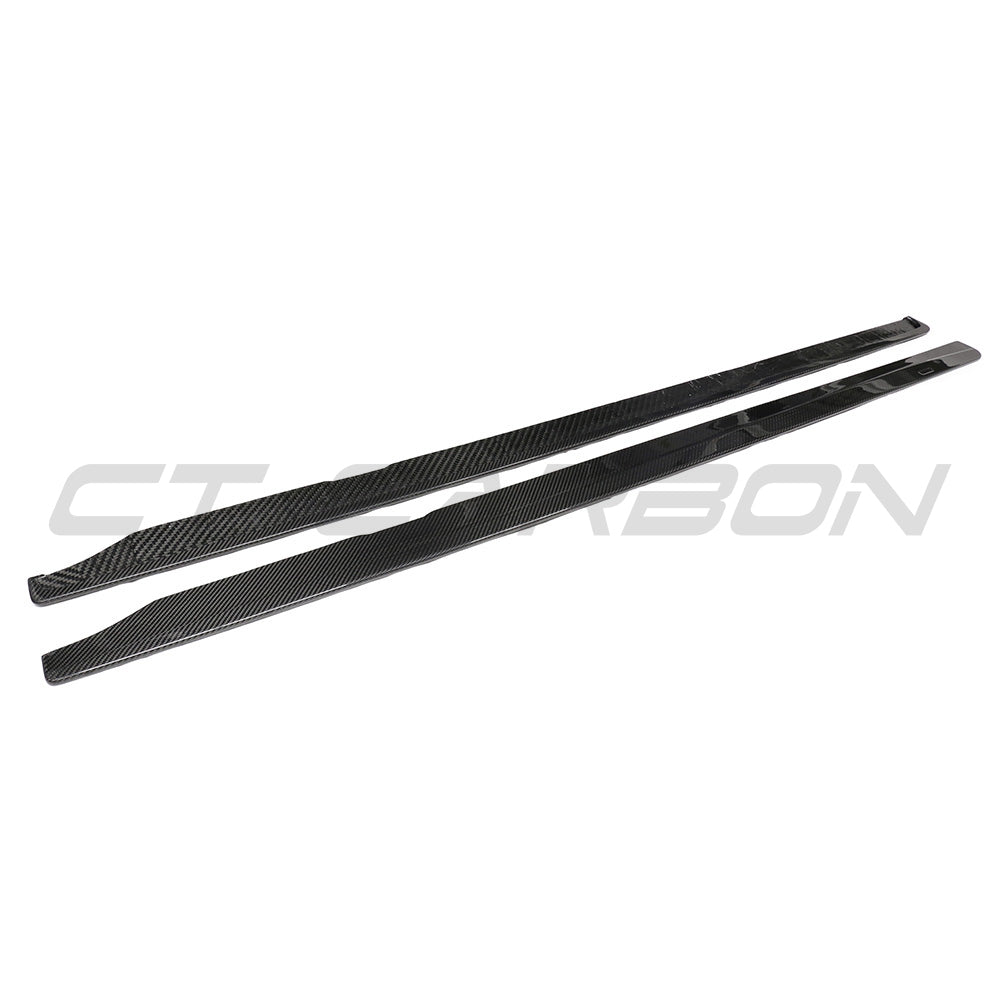 BMW G87 M2 carbon fibre side skirts by CT Carbon, showcasing sleek aerodynamic design and textured carbon fiber surface.
