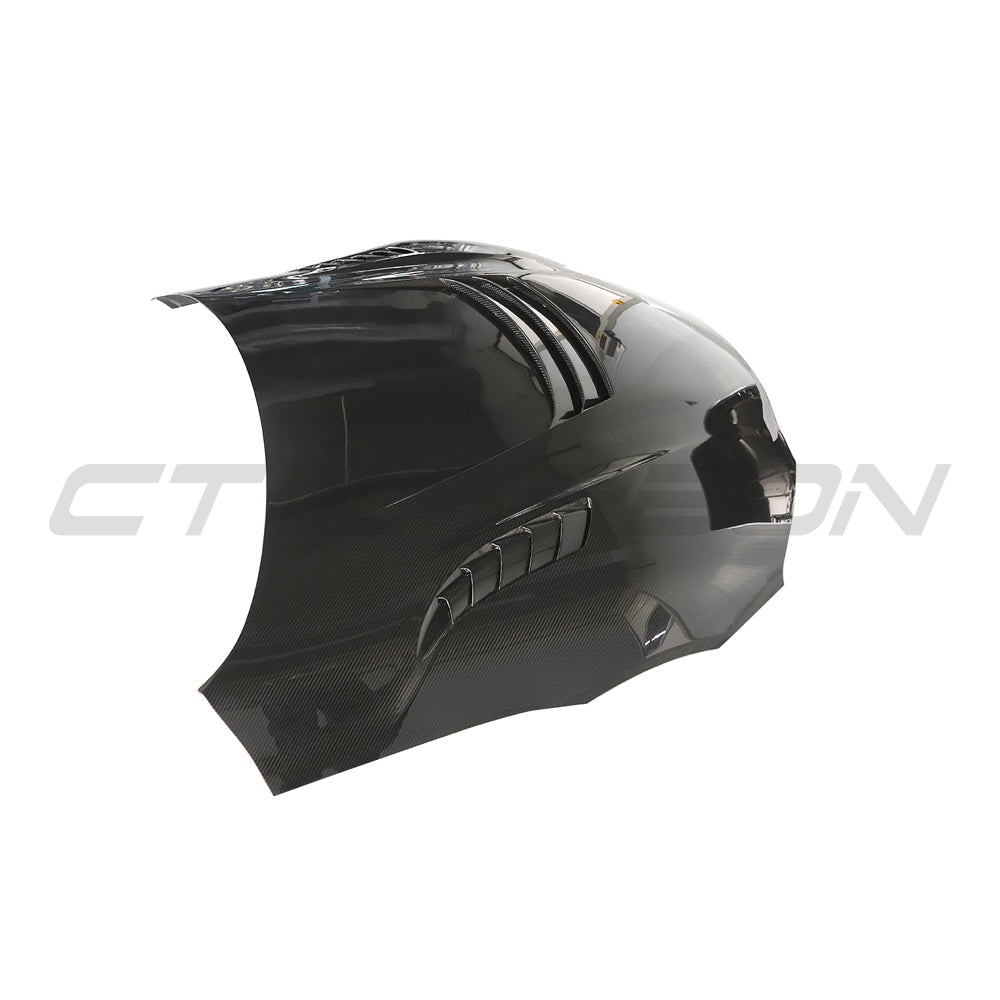 Toyota Supra 2019+ A90 carbon fiber front hood by CT Carbon, showing close-up of lightweight, glossy carbon fiber surface.