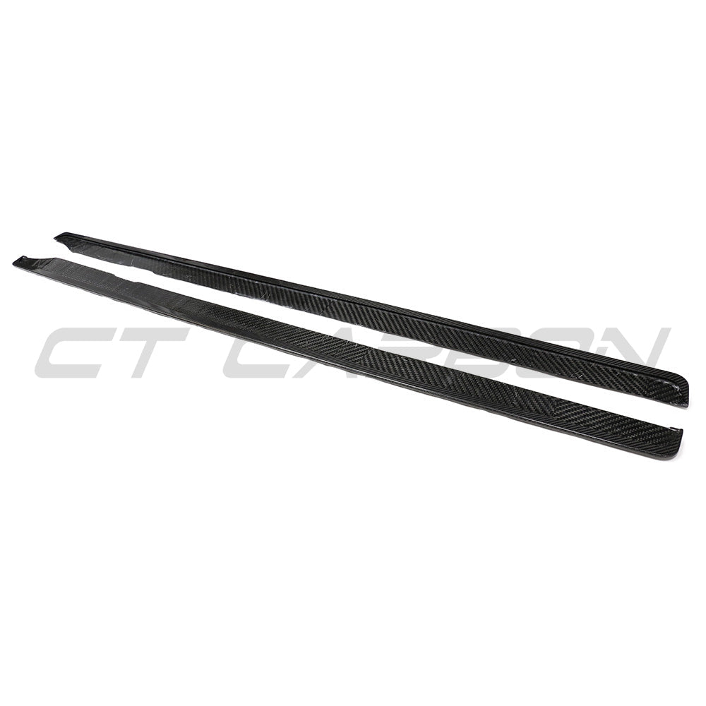 BMW G87 M2 carbon fiber side skirts by CT Carbon, showcasing sleek, aerodynamic design and textured carbon fiber surface.