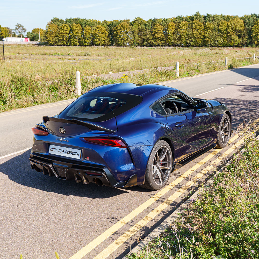 Carbon fiber diffuser add-on for 2019+ Toyota Supra A90 by CT Carbon, featuring sleek aerodynamic design and high-quality finish.