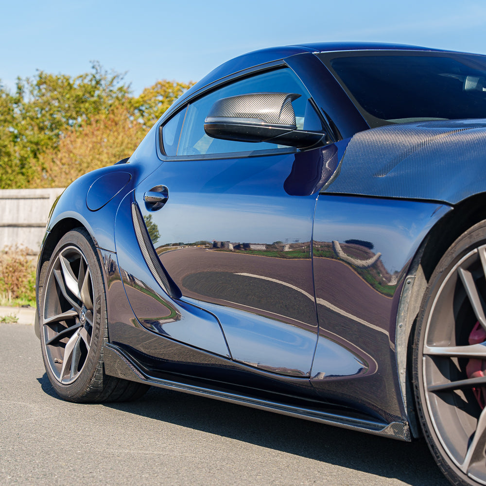 Carbon fiber side skirts for Toyota Supra 2019+ A90 by CT Carbon, showcasing sleek design and detailed craftsmanship.
