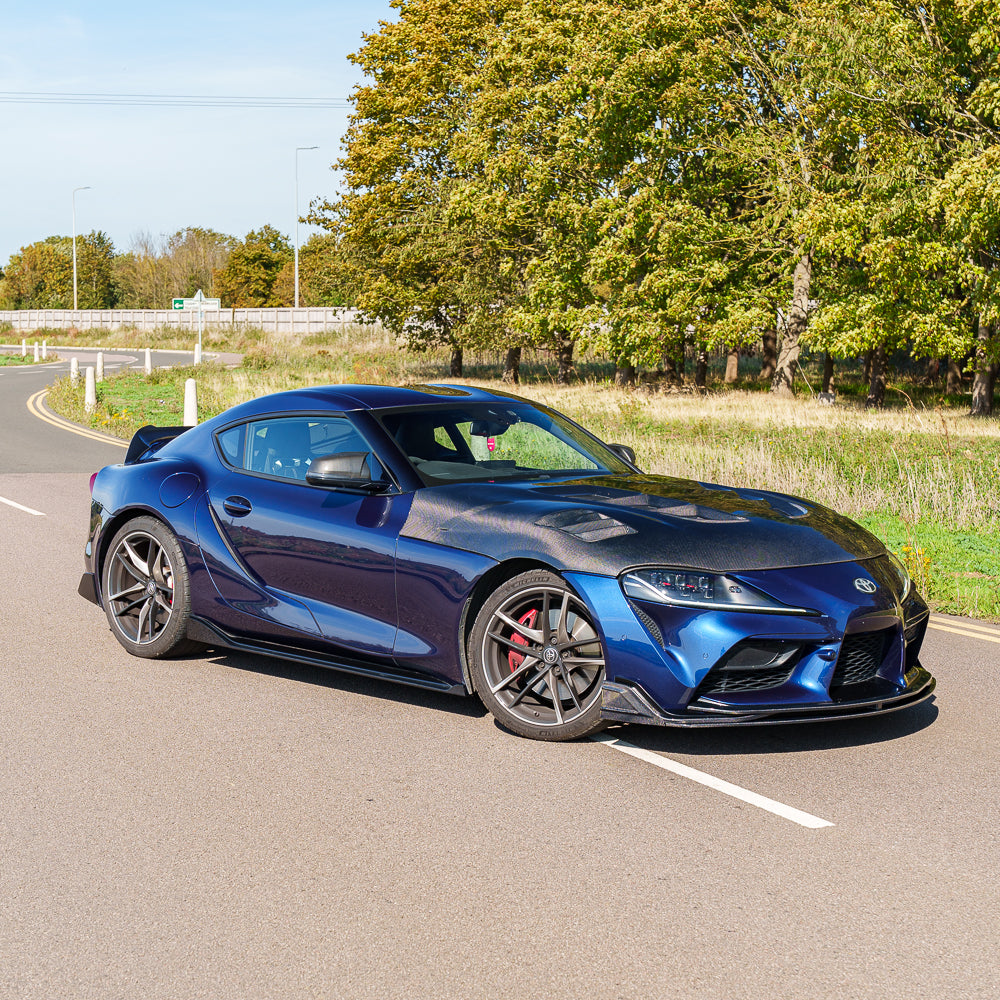 Carbon fiber side skirts for Toyota Supra 2019+ A90 by CT Carbon, shown installed on the vehicle's sides.