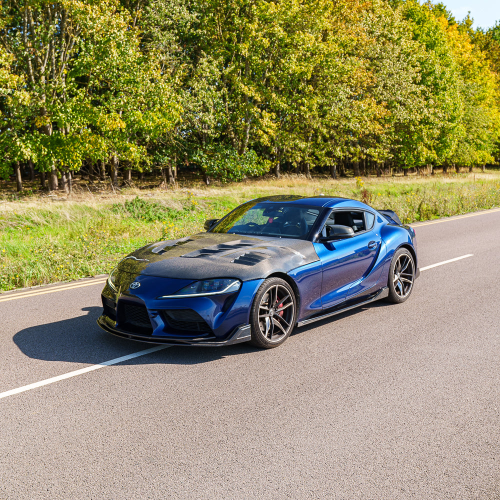 Toyota Supra 2019+ A90 V2 carbon fibre kit by CT Carbon, showing close-up of sleek, glossy carbon fibre parts on the full car kit.