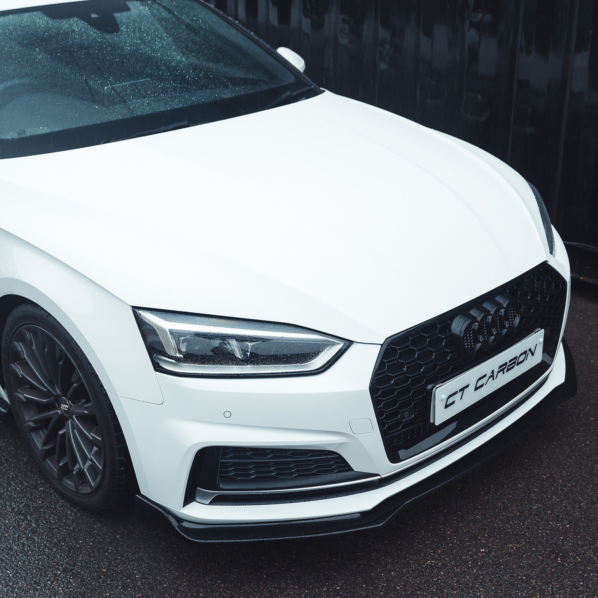 Audi A5/S5 B9 2016-2019 CT Carbon gloss black splitter, close-up view showing sleek aerodynamic design.
