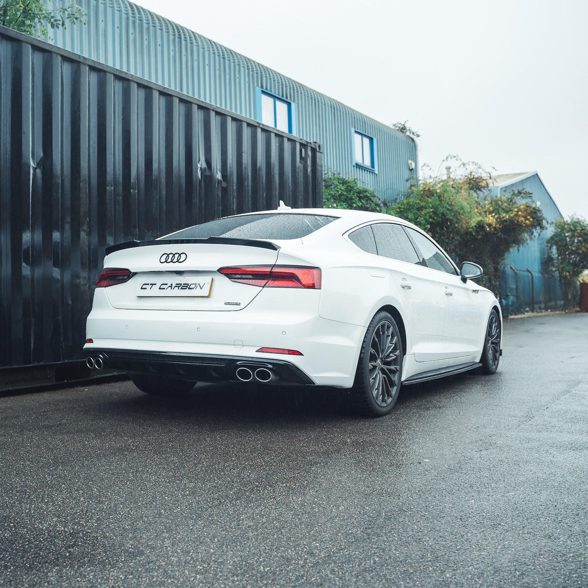 Gloss black spoiler for Audi A5/S5 B9 Sportback by CT Carbon, shown installed on the vehicle's rear for a sleek, aerodynamic look.