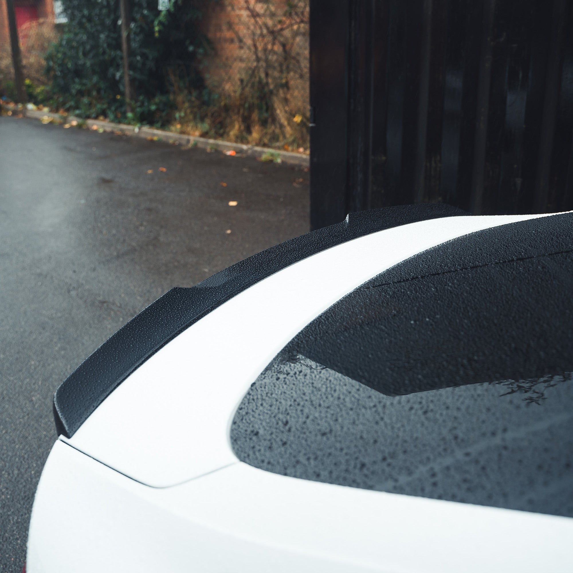 Gloss black spoiler for AUDI A5/S5 B9 Sportback by CT Carbon, mounted on the rear of the vehicle, enhancing sporty look.