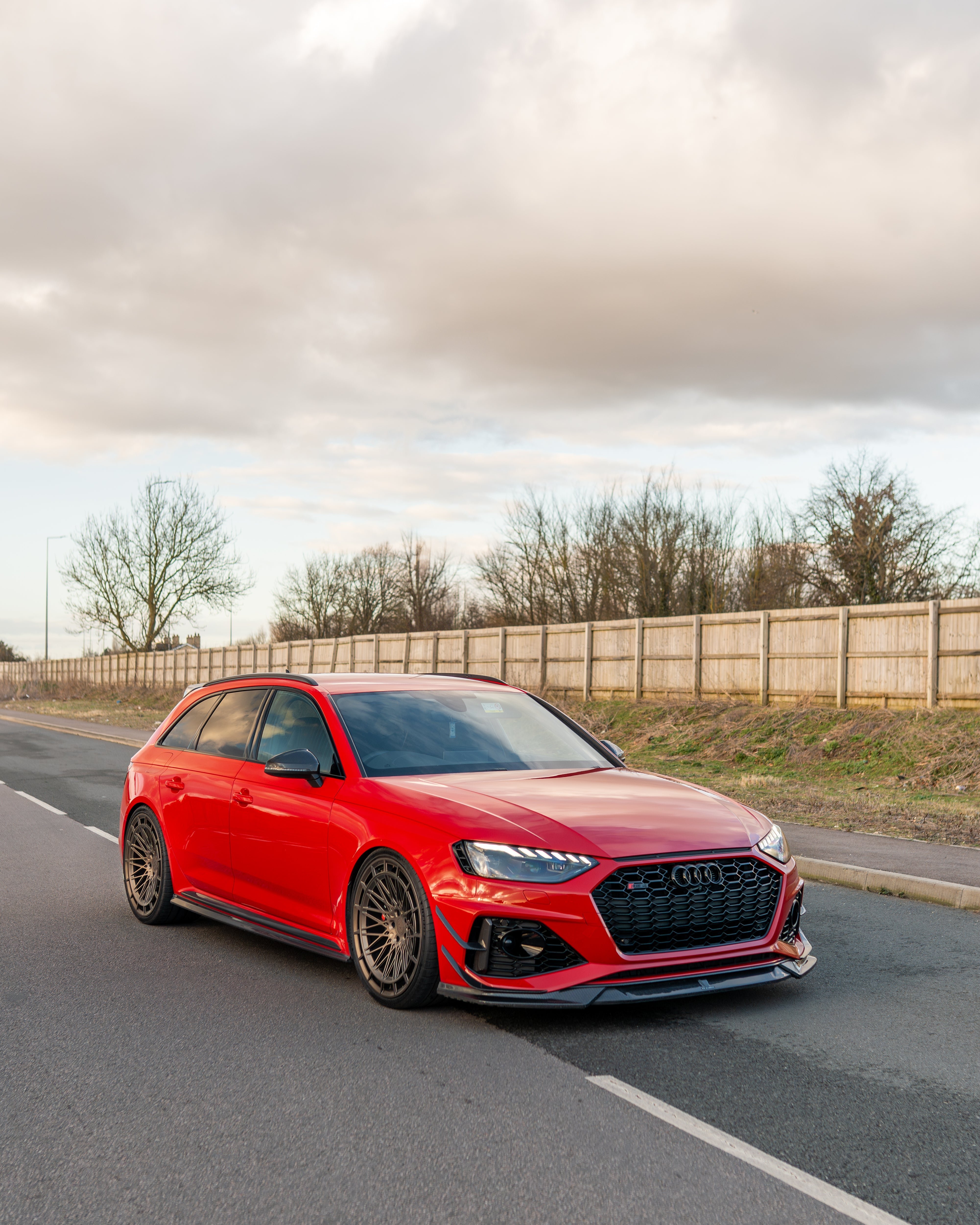 Audi RS4 B9.5 carbon fiber splitter by CT Design, shown on the front of the sporty sedan with sleek carbon fiber finish.