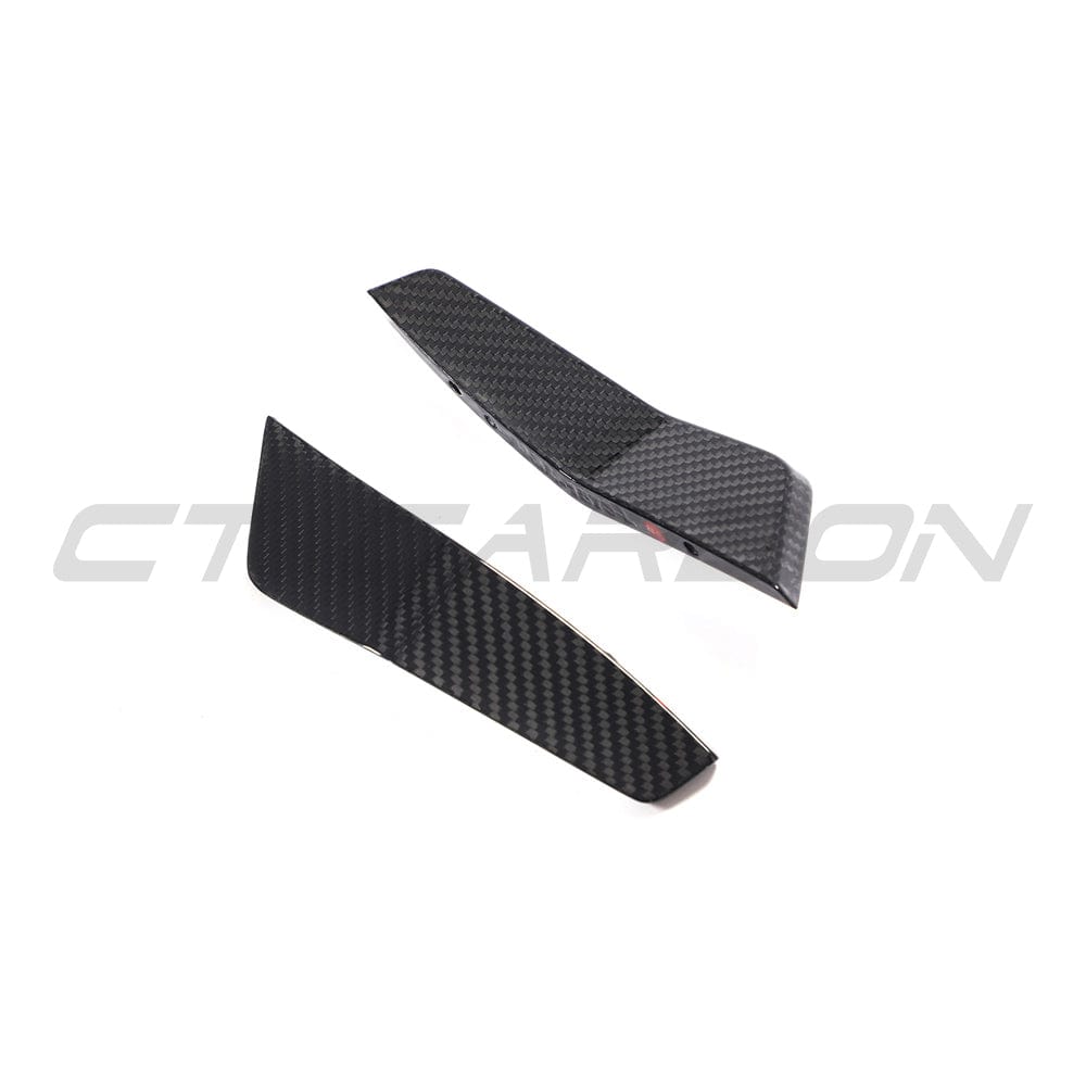Carbon fiber canards for Audi RS6 and RS7 C8 Avant models, accessory by CT Carbon, mounted on the front of the vehicle.