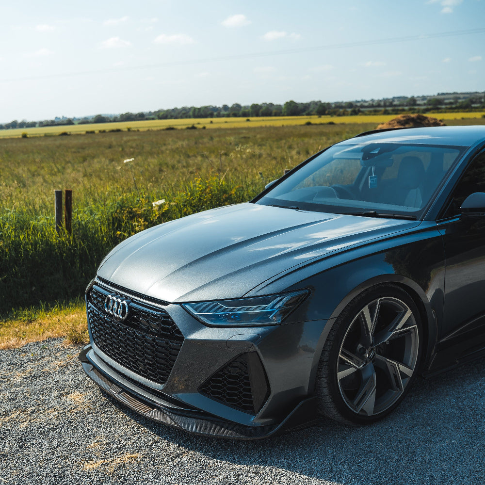 Audi RS6 RS7 C8 Avant carbon fiber splitter by CT Design, showing the sleek, textured carbon fiber surface and aerodynamic design.