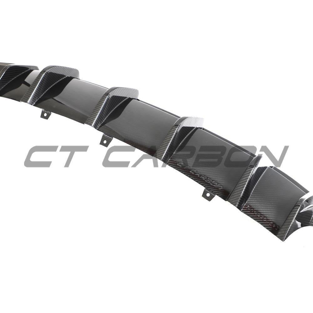 Carbon fiber diffuser for Audi RS6 and RS7 C8 models by CT Design, showcasing sleek, textured carbon fiber surface on the car's rear.