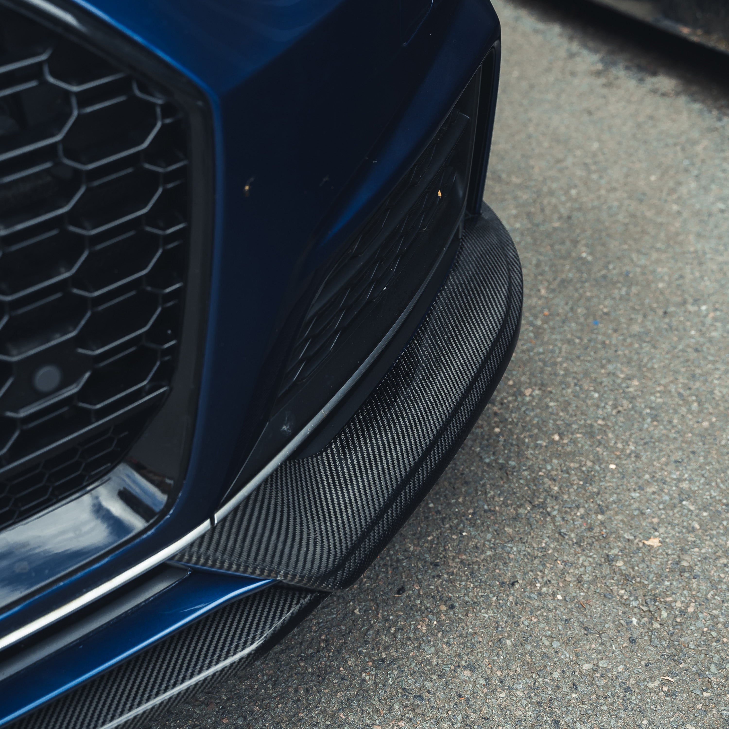 Carbon fiber splitter for Audi A5 S5 B9 (2017-2021) by CT Carbon, showcasing the sleek, aerodynamic design on the car's front bumper.