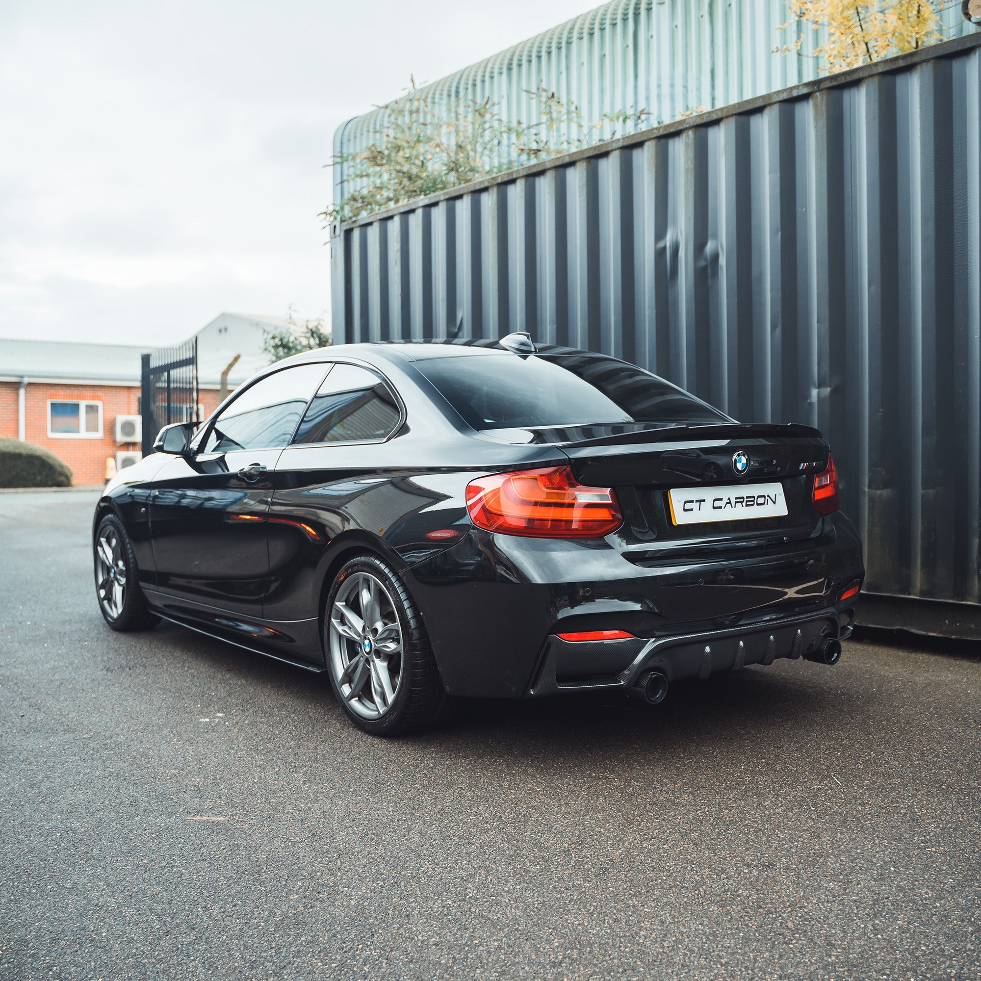BMW 2 Series F22/F23 carbon fibre diffuser by CT Carbon, showcasing sleek black vented design for enhanced aerodynamics.