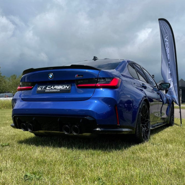 BMW 3 Series G80/G20 carbon fiber spoiler by CT Carbon, featuring a sleek pre-preg carbon fiber finish on a sporty car.