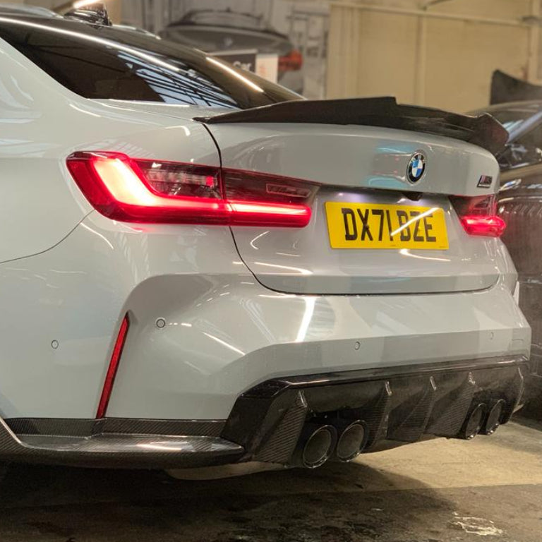 BMW M3 G80 G20 carbon fibre spoiler by CT Carbon, showcasing sleek V6 design on a dark car with visible carbon texture.