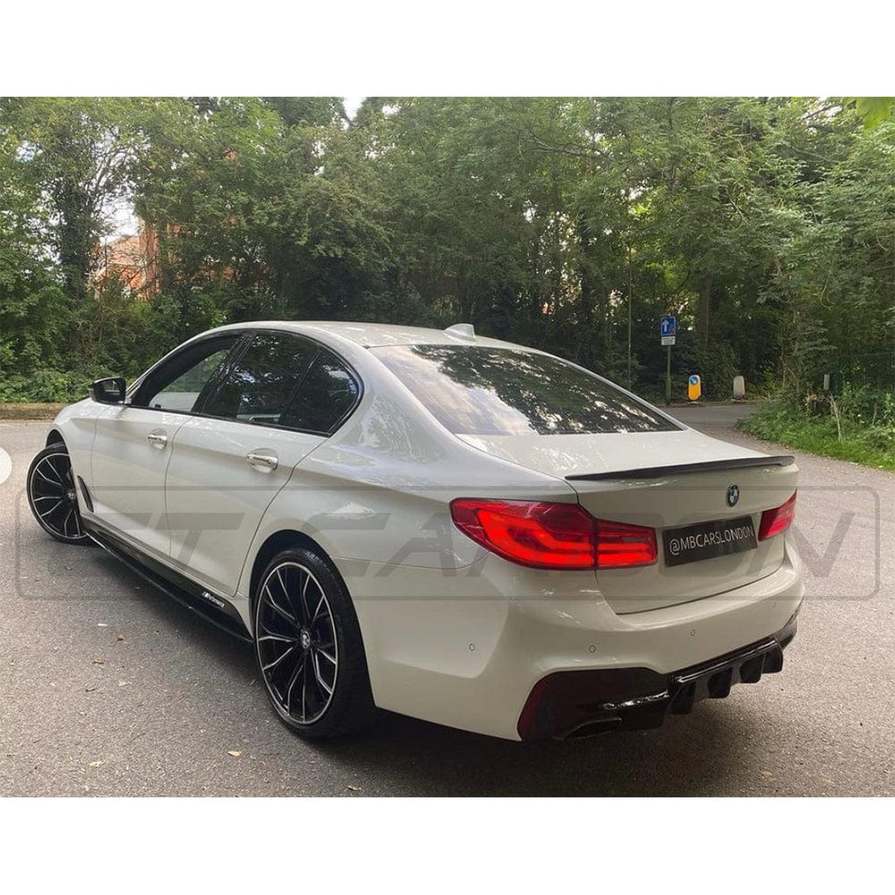 BMW 5 Series G30 gloss black full kit by CT Carbon, M5-style exterior upgrade, featuring sleek black accents and carbon fiber details.
