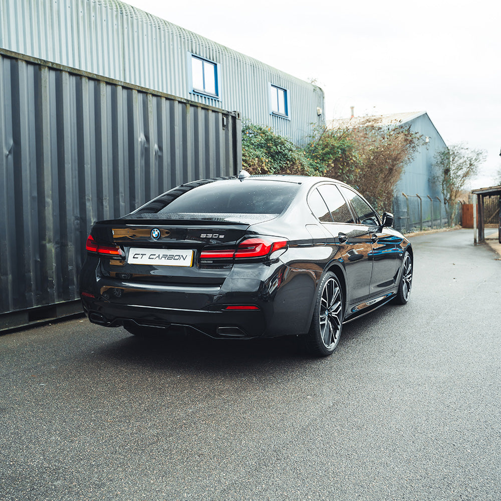 BMW 5 Series G30 LCI 2021+ CT Carbon gloss black kit installed on vehicle, featuring V4 style accents and sleek black finish.