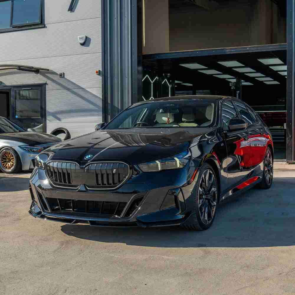 BMW 5 Series G60 and i5 2023 CT Carbon gloss black splitter installed on front bumper, enhancing sporty appearance.