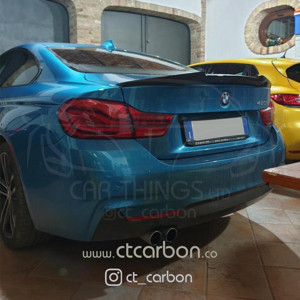 BMW F36 4 Series coupe with CT Carbon full carbon fiber kit and twin exhaust, showcasing sleek, glossy carbon fiber details.