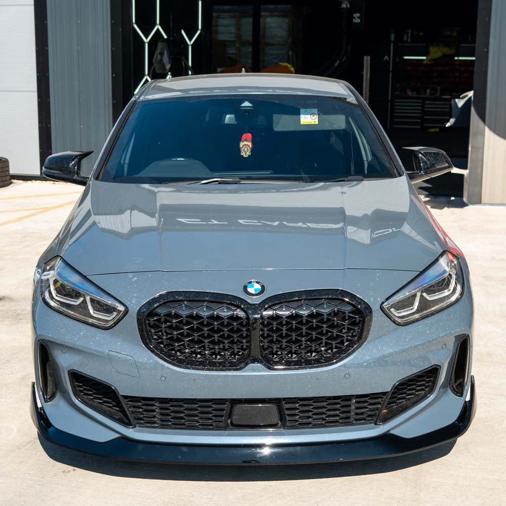 BMW F40 1 Series Gloss Black Splitter by CT Carbon, V1 style, showcasing the sleek aerodynamic front splitter on the vehicle.