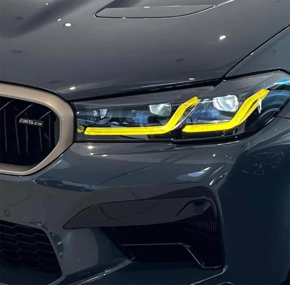 BMW F90 M5 LCI yellow adaptive DRL module set by CT Carbon, showcasing the bright yellow daytime running lights on the vehicle.
