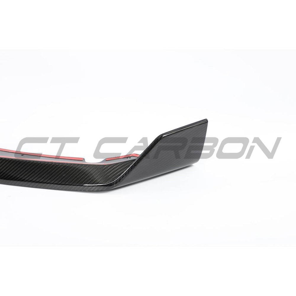 BMW F95 X5M 2023+ LCI carbon fibre splitter by CT Carbon, shown installed on the front of the vehicle.