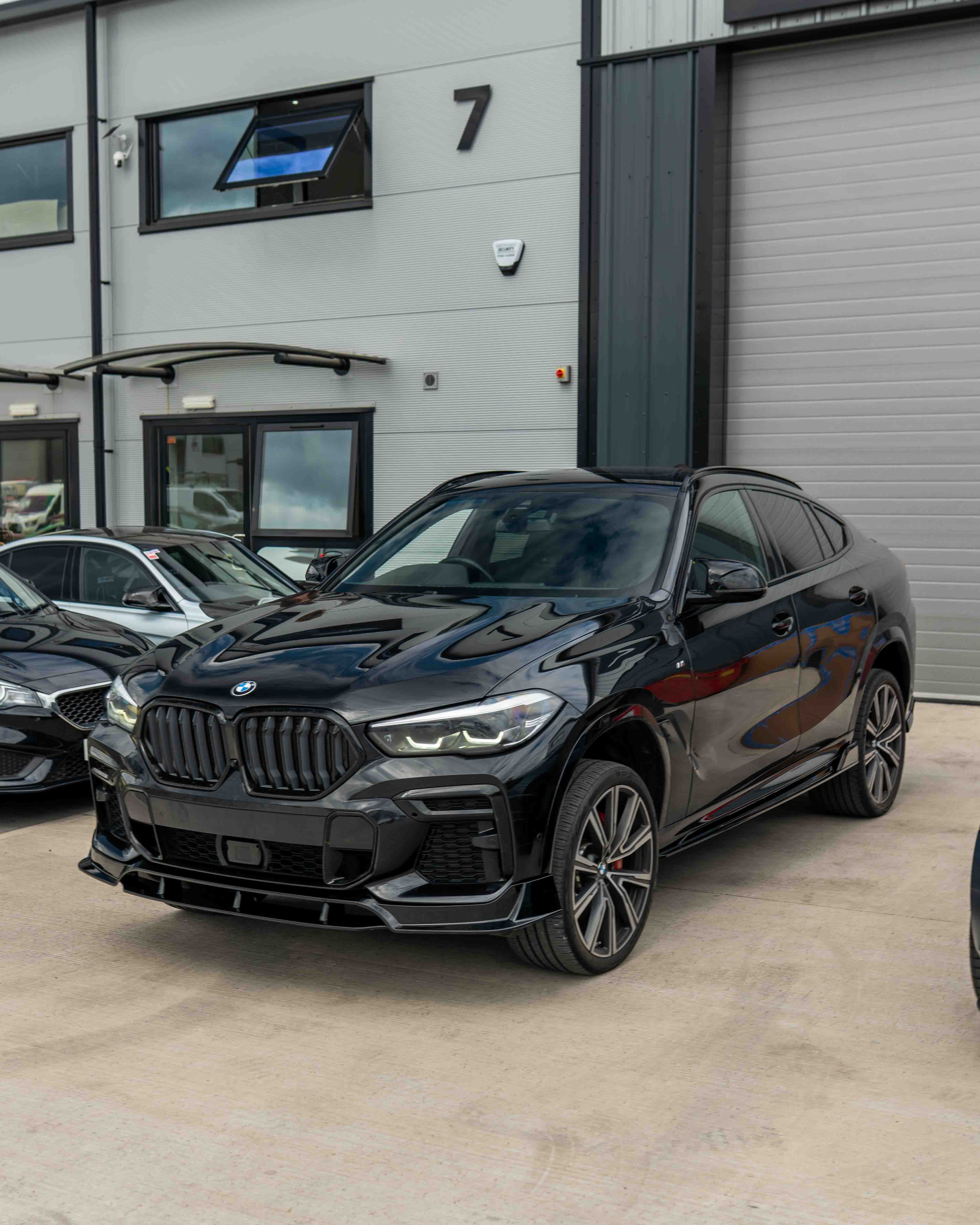 Full gloss black kit for BMW G06 X6 Pre-LCI 2020-2024 by CT Carbon, shown on a sleek vehicle with matching black accents.