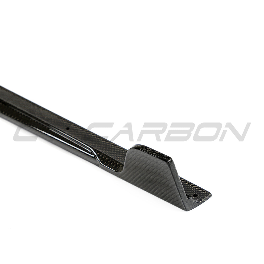 BMW G42 2 Series 2022+ full carbon fiber side skirts by CT Carbon on the car's side, showcasing a sleek, high-performance upgrade.
