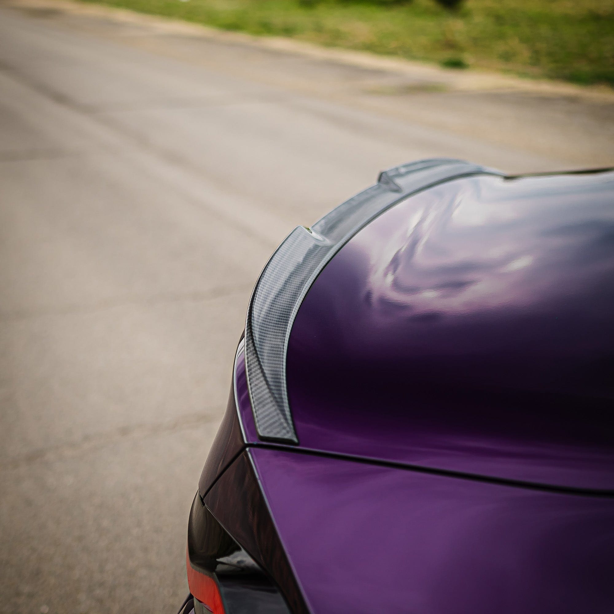BMW G87 M2 and G42 2 Series carbon fibre spoiler by CT Carbon, V2 style, installed on the car, showcasing sleek aerodynamic design.