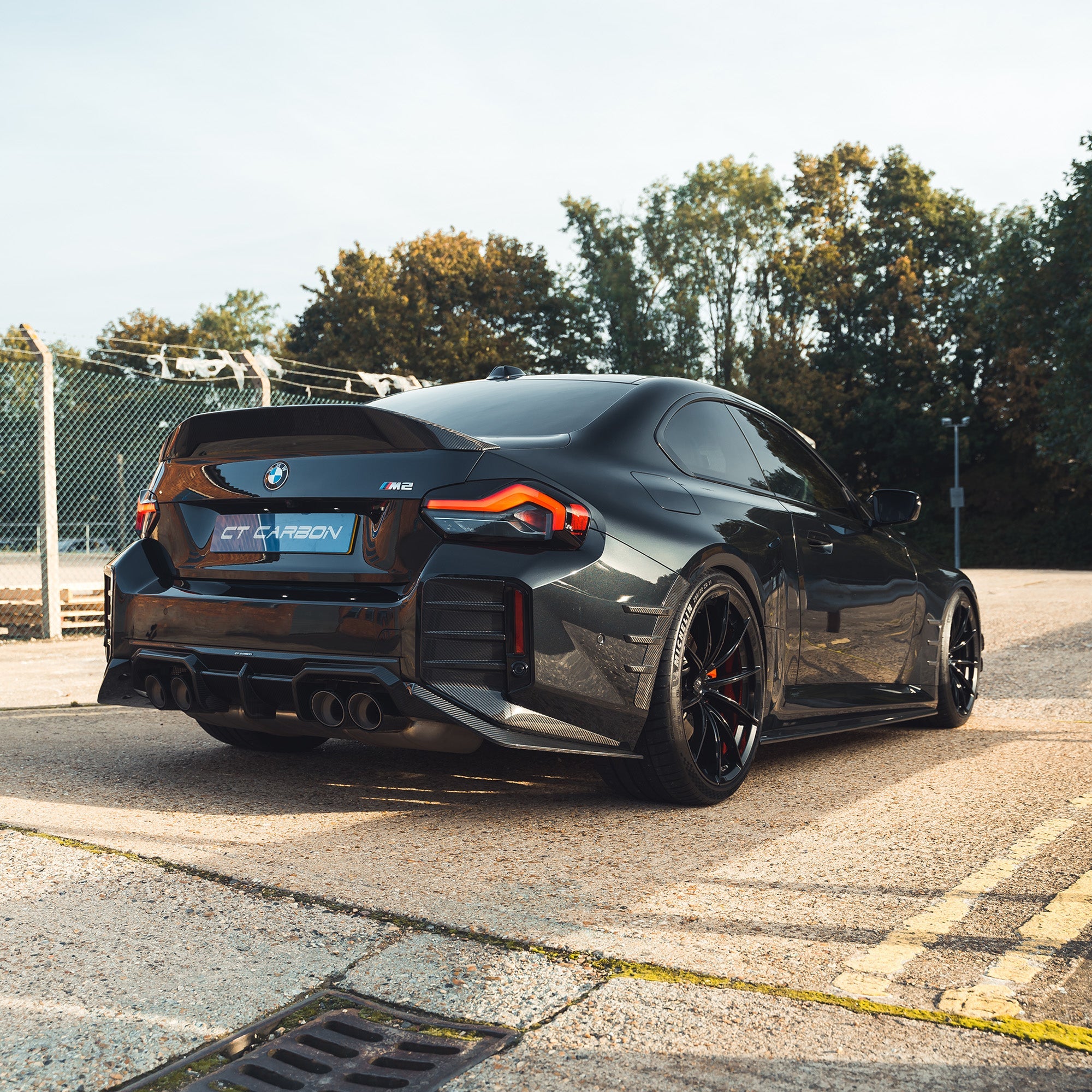 BMW G87 M2 carbon fiber diffuser by CT Design, showcasing a sleek, aerodynamic rear diffuser with carbon fiber finish.