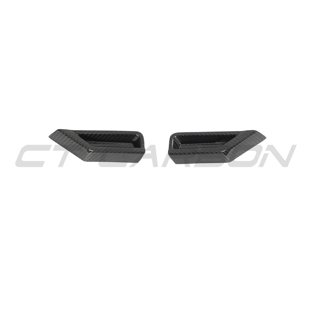 BMW G87 M2 carbon fiber front headlight add-on accessory by CT Design showing sleek carbon fiber detail on the headlight area.