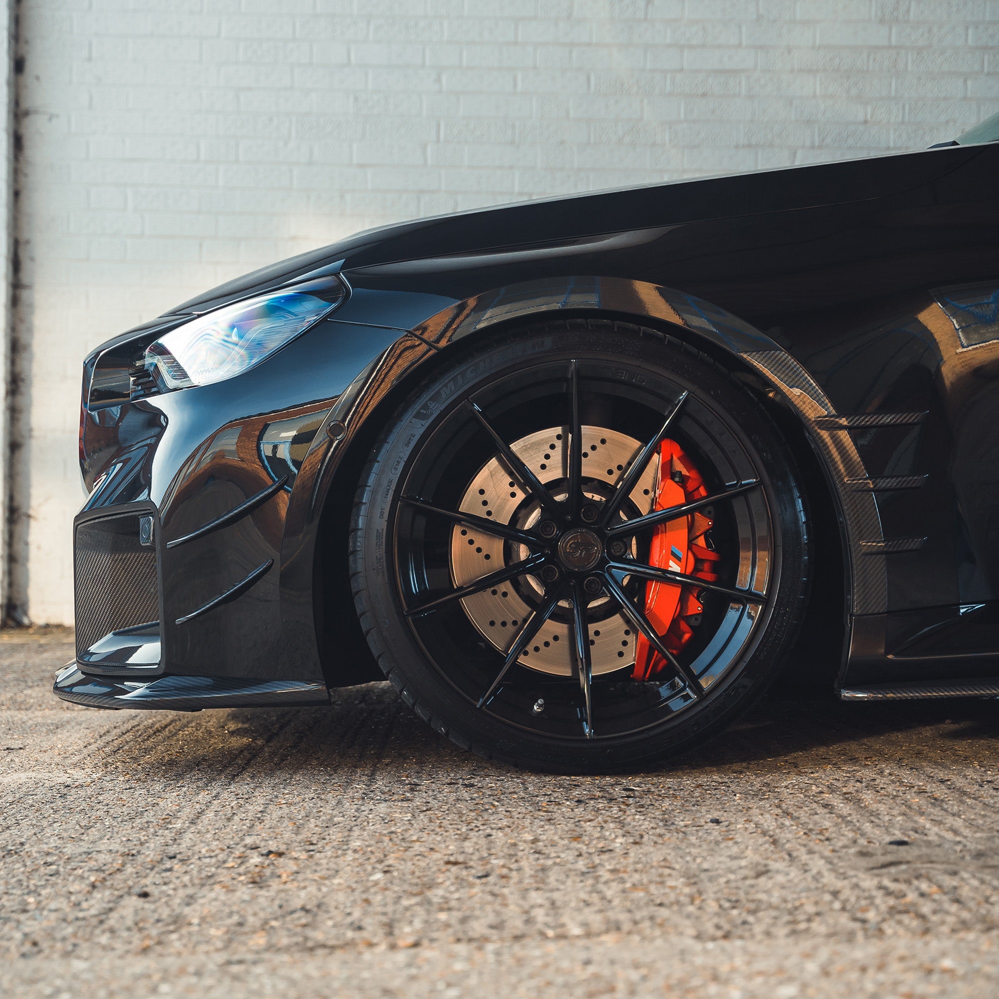 BMW G87 M2 carbon fiber front side fender trim accessory by CT Carbon, showcasing sleek, lightweight exterior detail.