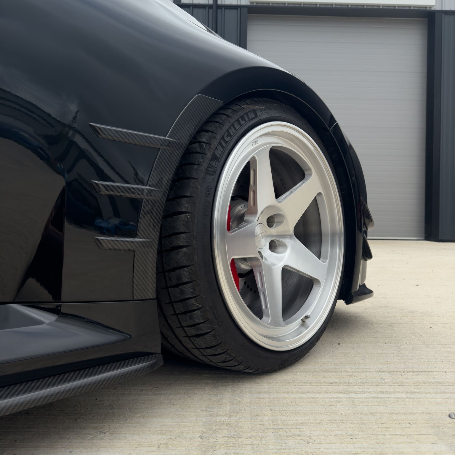 BMW G87 M2 carbon fibre front side fender trim accessory by CT Carbon, showcasing sleek, lightweight automotive enhancement.