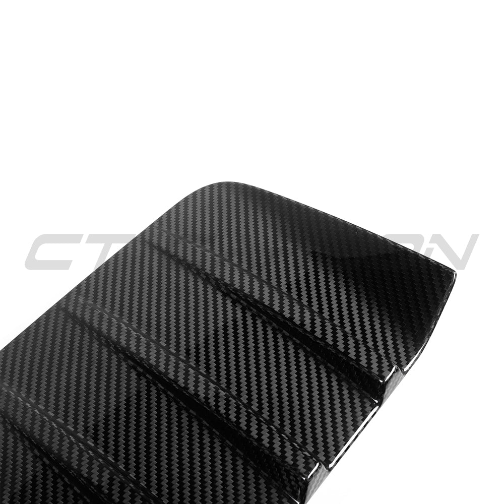 BMW G87 M2 carbon fiber rear bumper trim accessory by CT Carbon, showing close-up of sleek, lightweight carbon fiber finish.