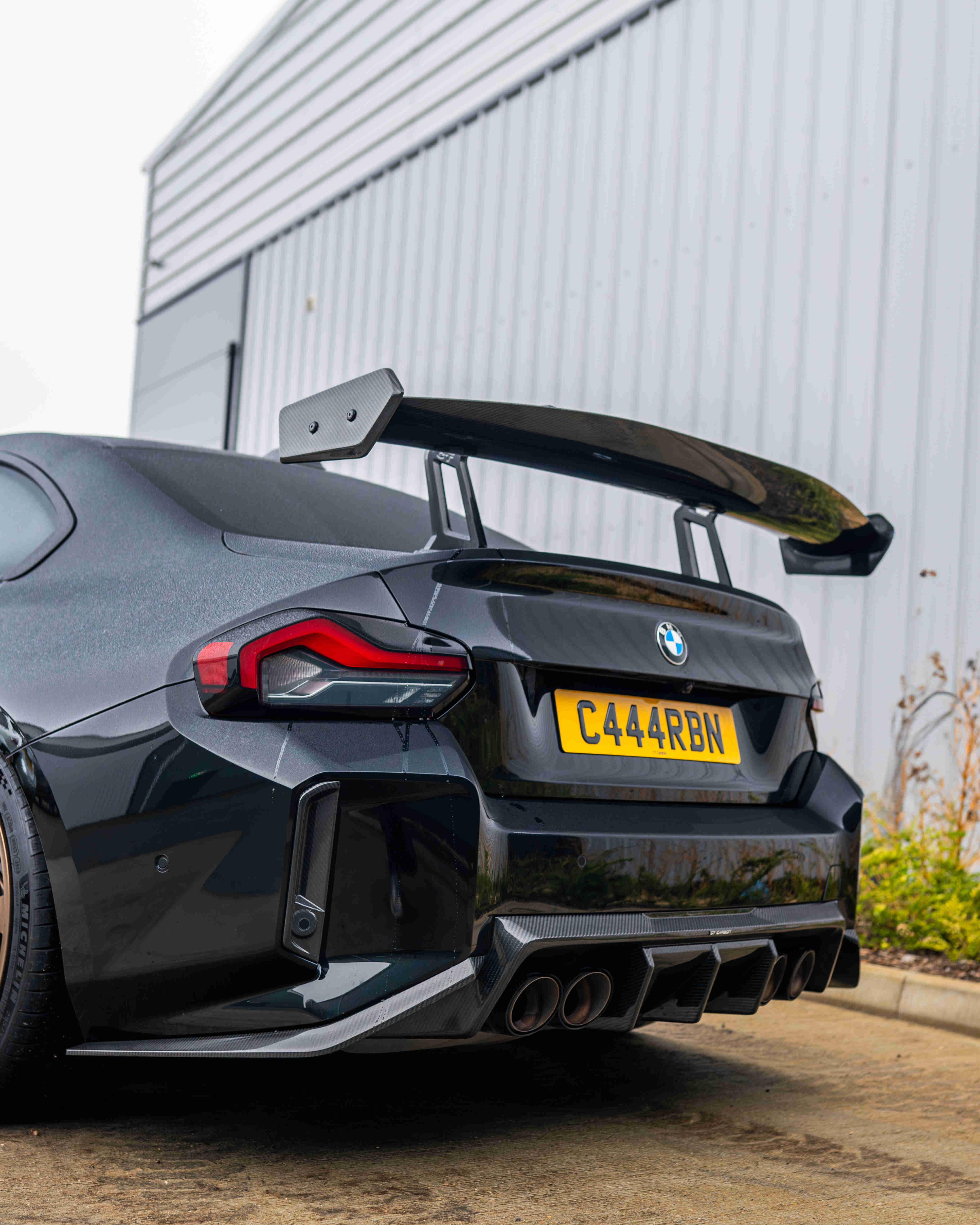 BMW G87 M2 and G42 2 Series carbon fibre swan neck wing spoiler by CT Carbon, showing its sleek aerodynamic design