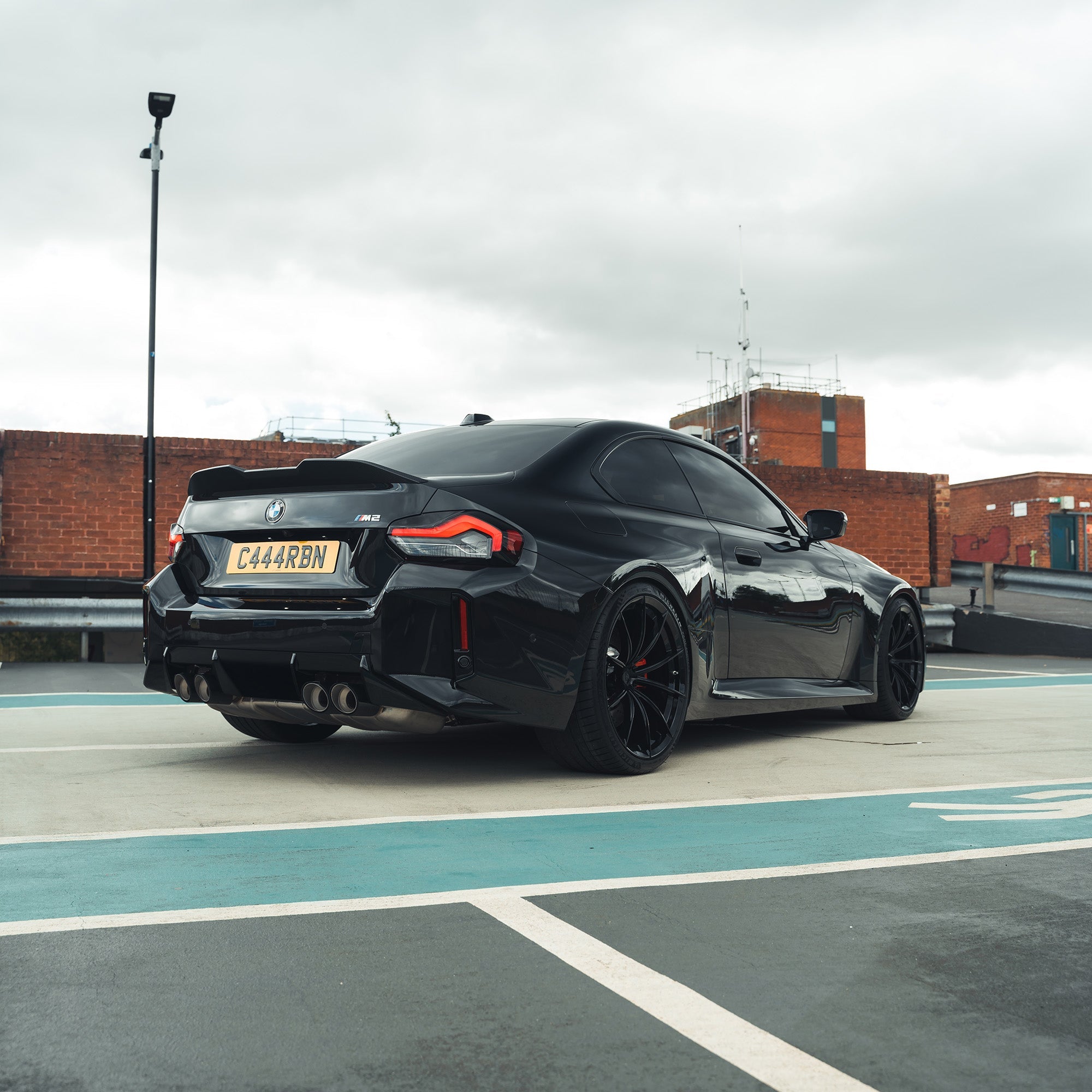 BMW G87 M2 and G42 2 Series carbon fibre spoiler by CT Carbon, front view showing sleek aerodynamic design.