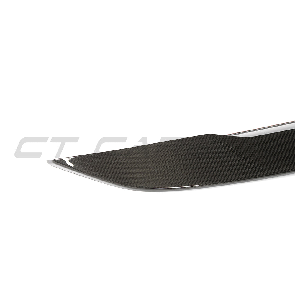 BMW G60 5 Series carbon fibre full kit by CT Carbon, including spoiler and body panels, showcased on a blue vehicle.
