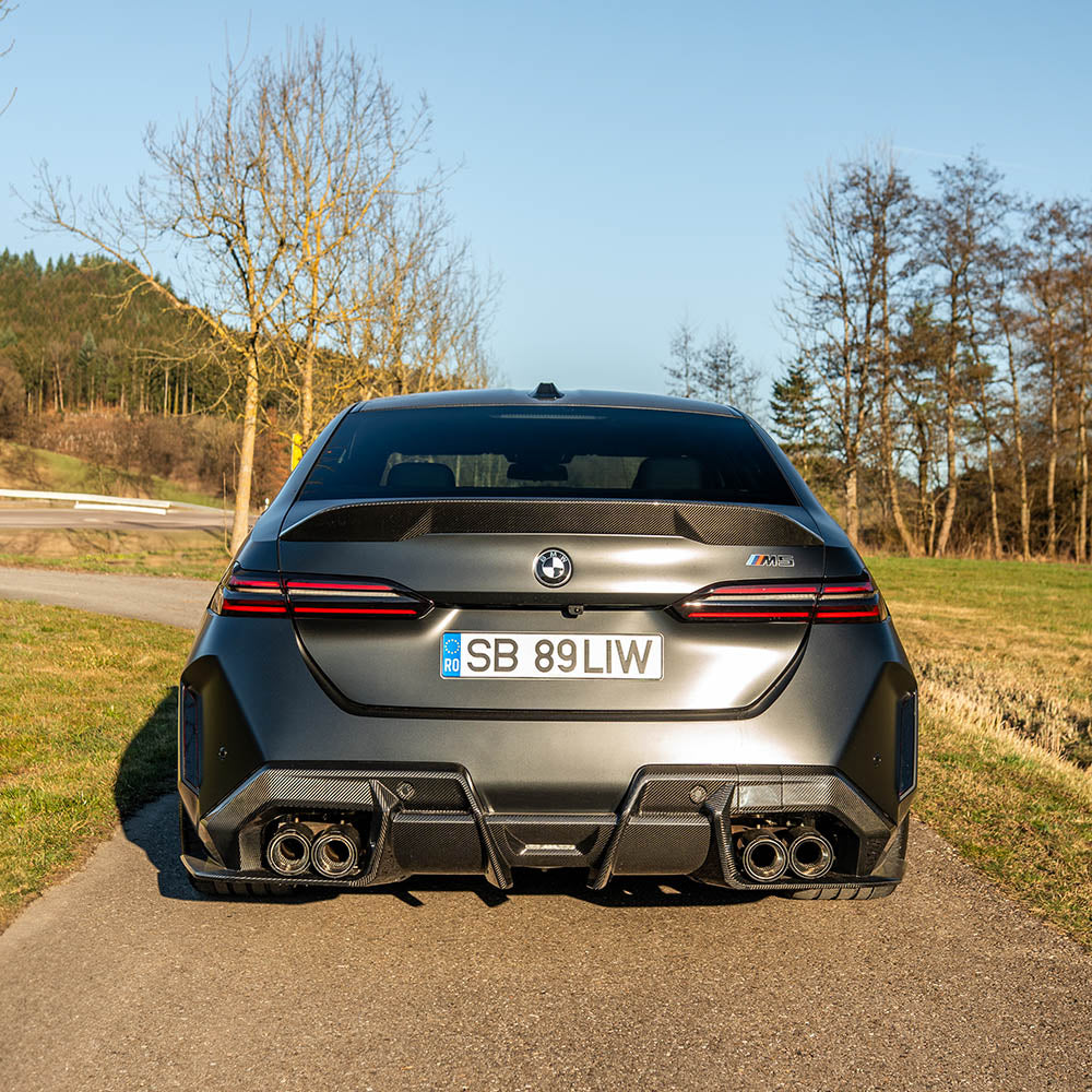 BMW G90 M5 carbon fibre full kit by CT Design, featuring a sleek carbon fibre spoiler and body enhancements on a 2023 G60 M5.