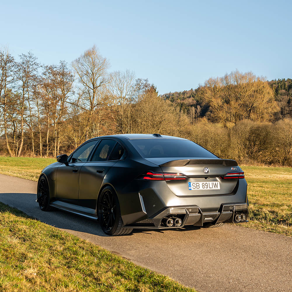 BMW G90 M5 carbon fibre full kit by CT Design, including spoiler and body accents, showcased on a 2023 G60 5 Series.