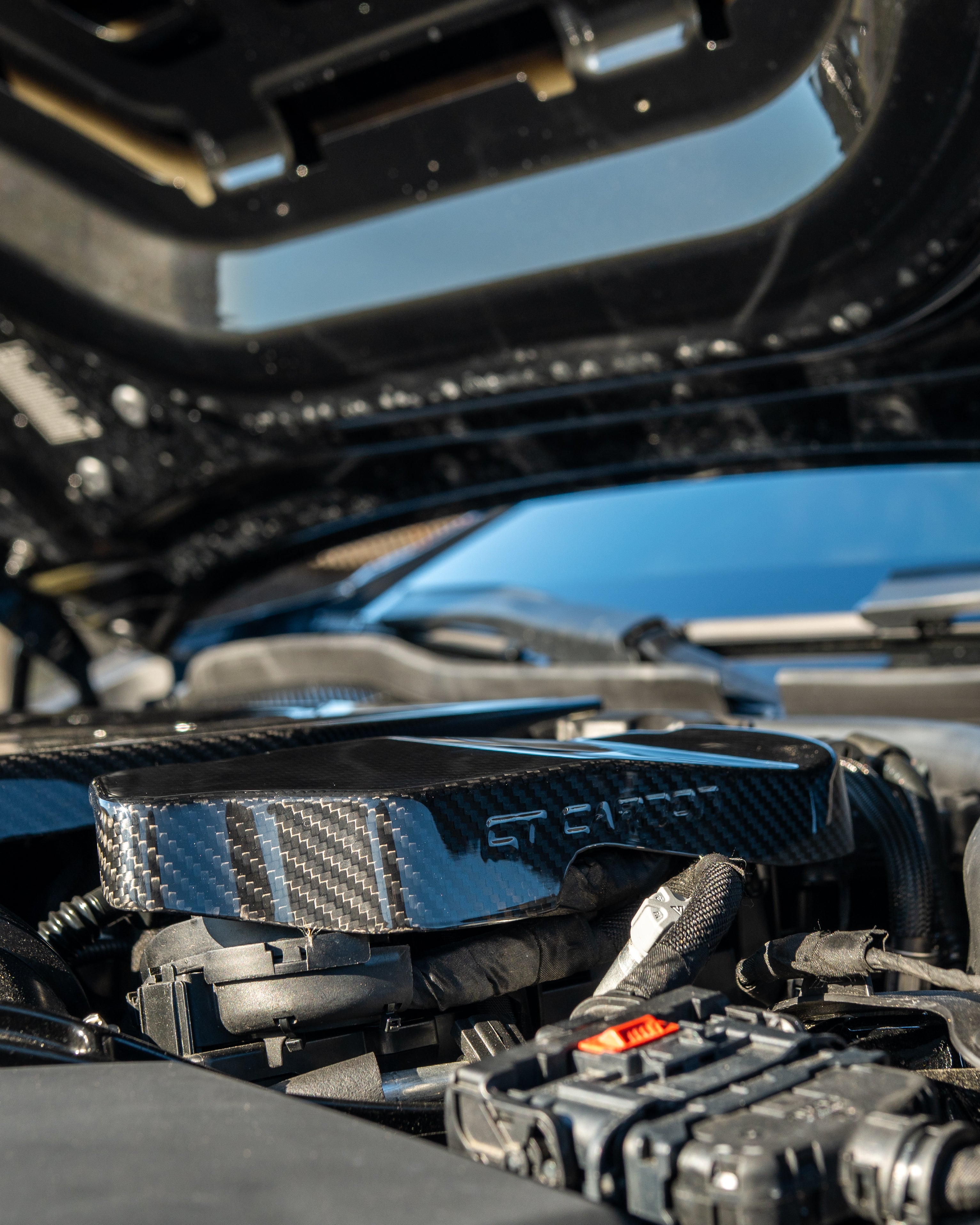 BMW G90 G99 M5 2024 carbon fibre engine bay covers by CT Carbon, shown installed in the engine compartment.