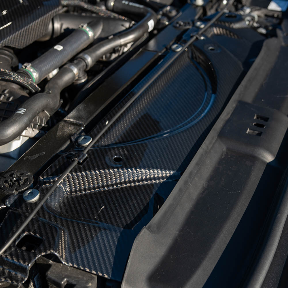 BMW G90 G99 M5 2024 carbon fibre slam panel by CT Carbon, front view showing sleek, lightweight automotive accessory.