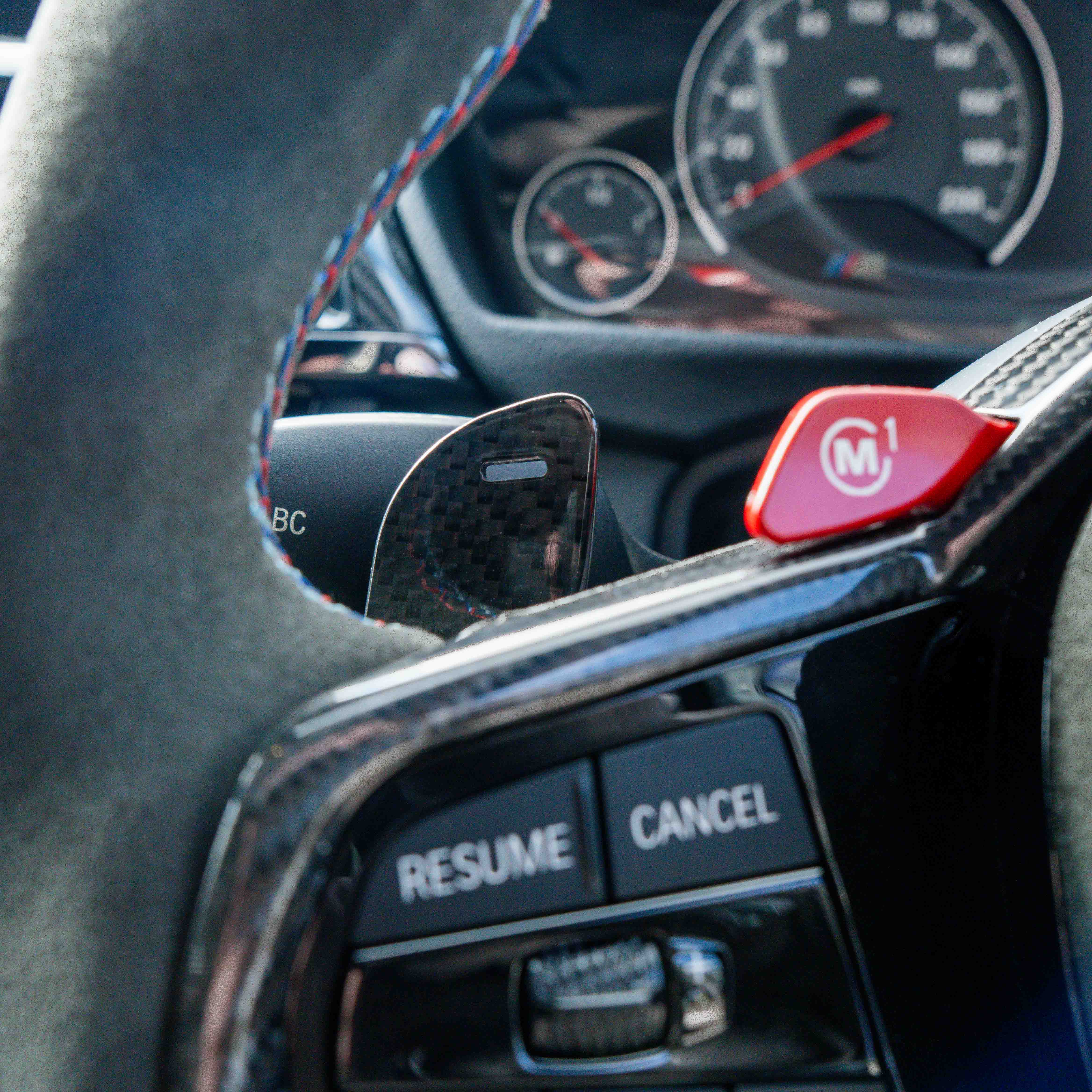 BMW Gxx carbon fiber magnetic shifter paddles by CT Carbon installed on a vehicle, showcasing sleek black design and quick shift access.