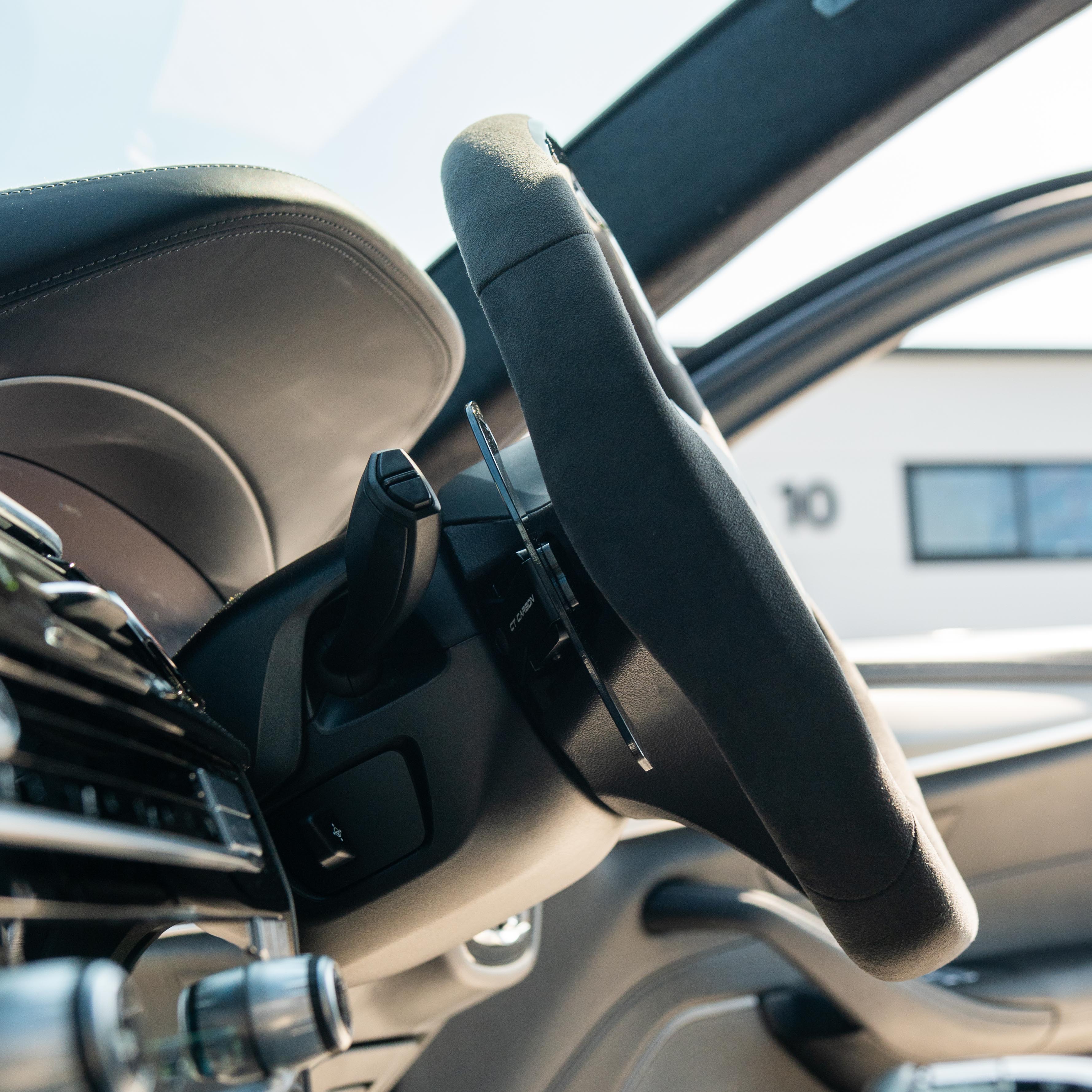 BMW Gxx carbon fibre magnetic shifter paddles by CT Carbon, close-up view showing sleek, lightweight racing-inspired design.