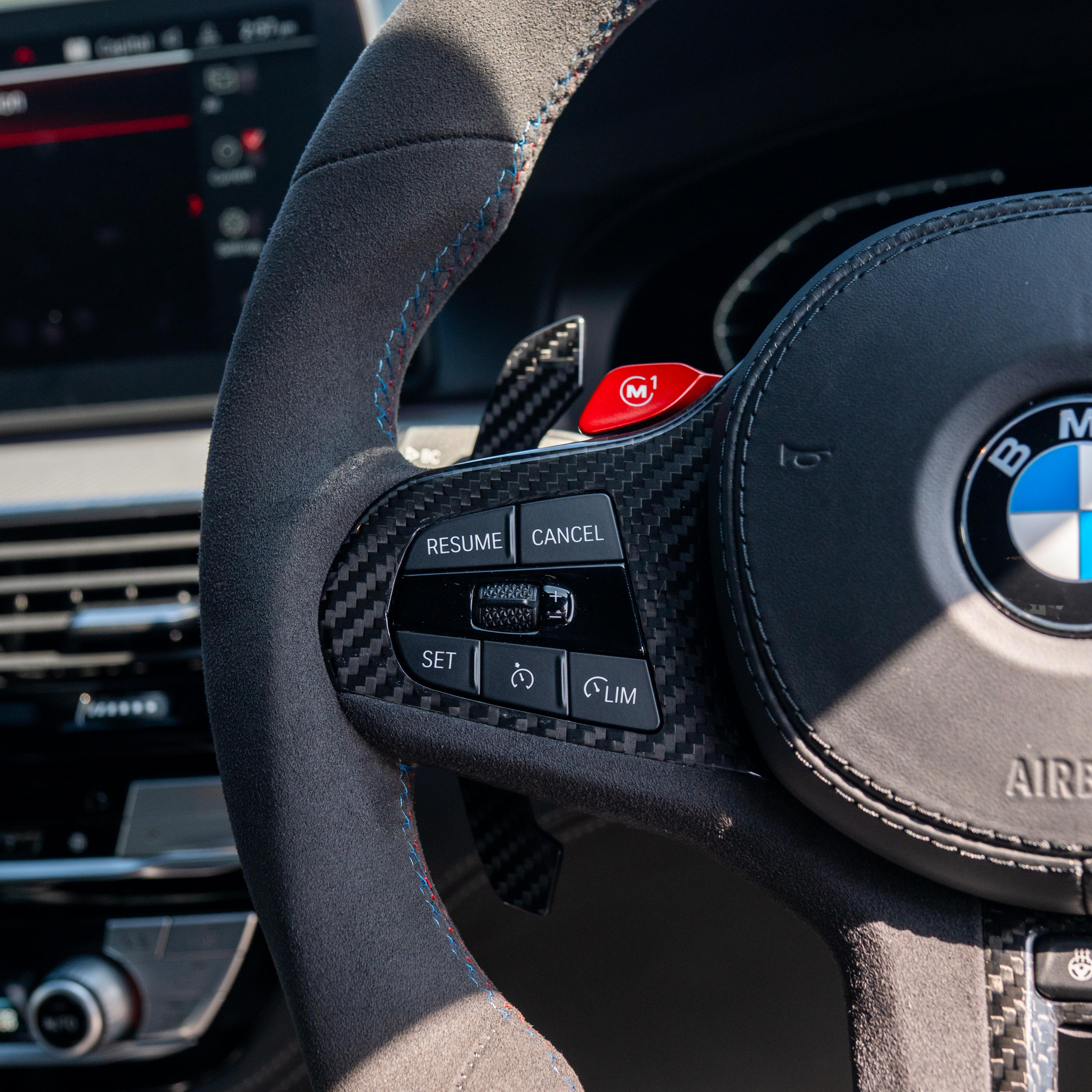 BMW Gxx carbon fibre magnetic shifter paddles by CT Carbon, close-up view showing sleek design and textured carbon surface.