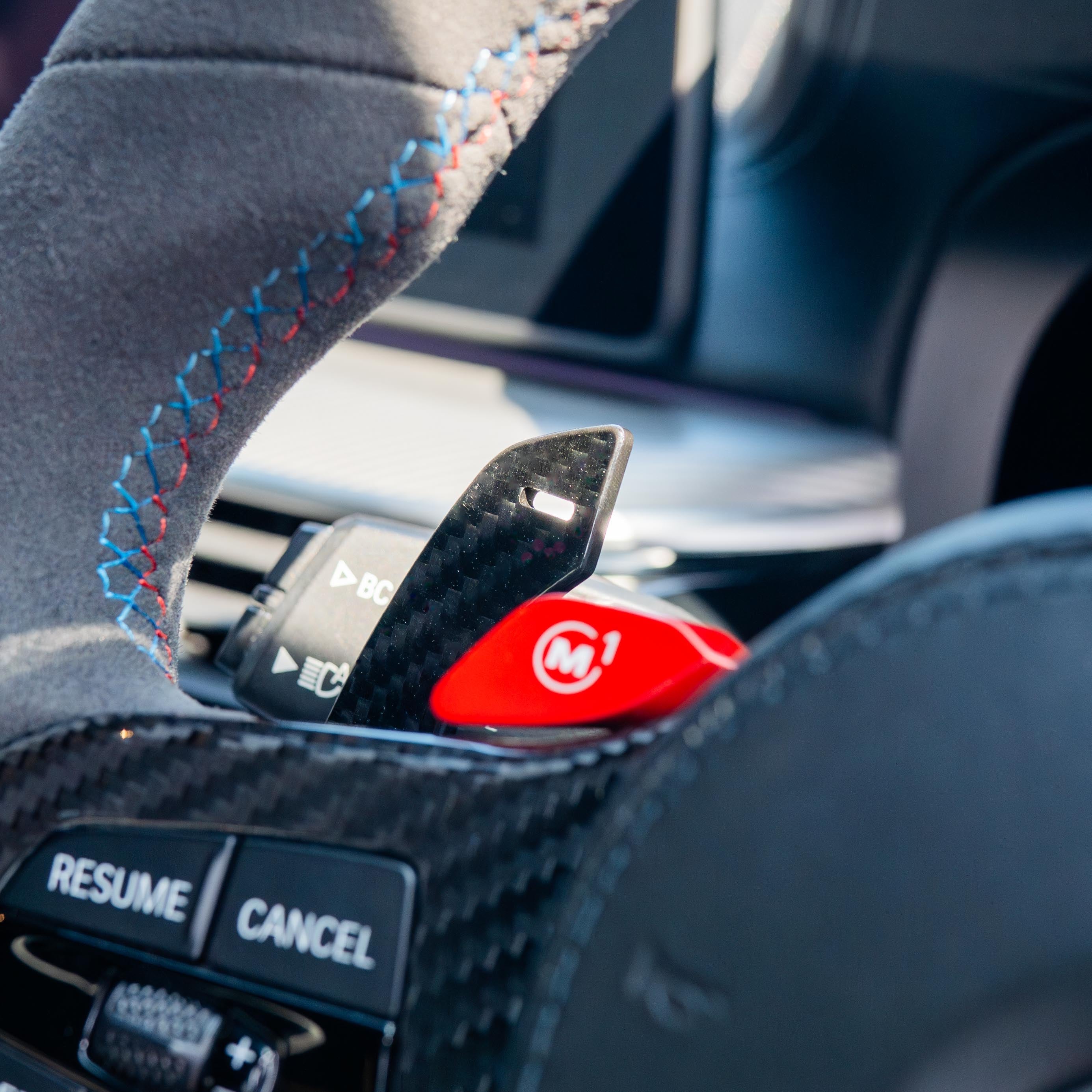 BMW Gxx carbon fibre magnetic shifter paddles by CT Carbon, close-up of sleek black lightweight racing-style accessories.