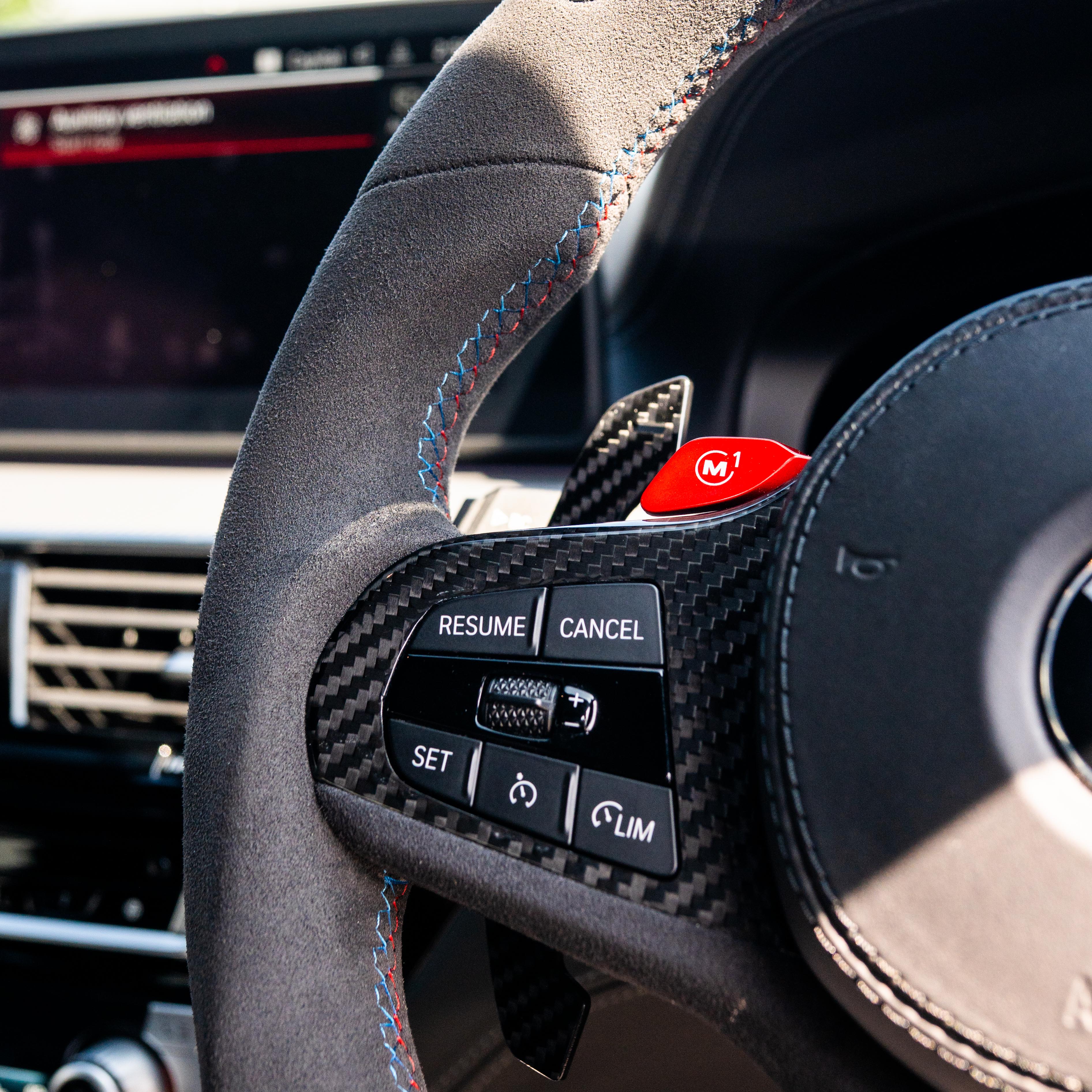 BMW Gxx carbon fiber magnetic shifter paddles by CT Carbon, close-up view showing sleek black finish and ergonomic design.