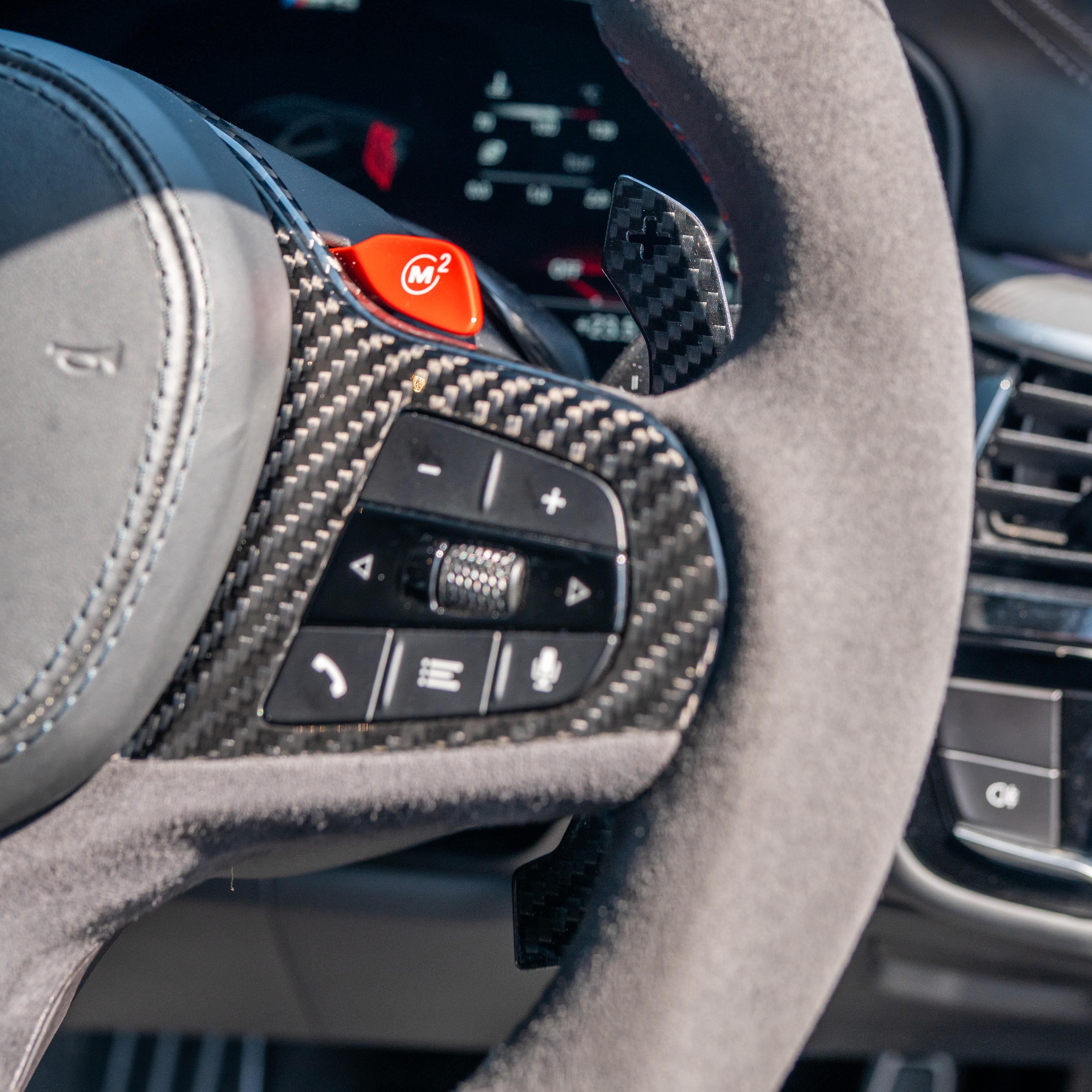 BMW Gxx carbon fibre magnetic shifter paddles by CT Carbon, close-up view showing sleek black aerodynamic design.